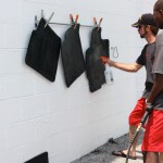 Shop manager Allen West sprays the Mazda floormats to kill the mold and mildew Shop manager Allen West sprays the Mazda floormats to kill the mold and mildew